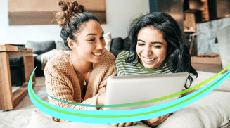 Two young women with dark hair (perhaps sisters or friends) in a living room smile at something on a tablet. “Fiber Flash” (Light blue streak with neon green highlights) flows across the image.